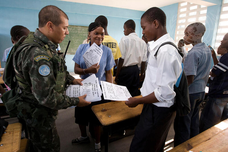 UN Peacekeeper Hands out Campaign against Life-like Toy Guns Flyer