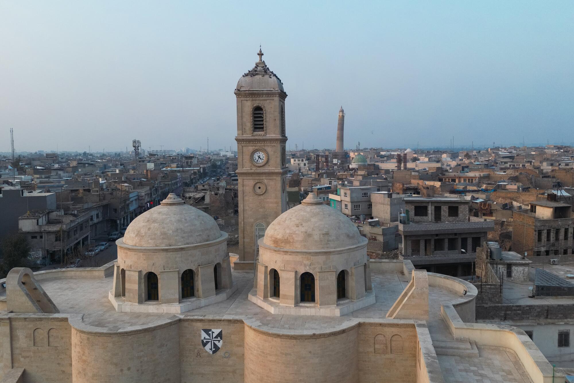 Mohamed Al Hassan (not pictured), Special Representative of the Secretary-General for Iraq and Head of the United Nations Assistance Mission for Iraq (UNAMI), attended the opening of the Grand Nuri Mosque and Al-Tahra Church in Mosul, Iraq, in the presence of Mohammed Shia` Al-Sudani, Prime Minister of the Republic of Iraq, as well as Noura bint Mohammed Al Kaabi, Minister of State at the Ministry of Foreign Affairs of the United Arab Emirates. 

"As we celebrate the rehabilitation of this mosque and its neighbor Al-Tahra Church, we are not celebrating the stones that have been rebuilt, but we are celebrating the revival of the Iraqi spirit. It is the symbol for the return of life, a mark of rejection of extremism, and the restoration of the values of co-existence that have been and remain a beacon of this country. I say this publicly: Mosul has returned and will return, and I call for the lifting of restrictions on Mosul and its people," said Mr. Al Hassan at the ceremony that celebrated the results of UNESCO’s reconstruction work under its Revive the Spirit of Mosul initiative, symbolizing a collective triumph of resilience, coexistence, and global solidarity.

A view of Mosul with the Al-Tahra Church in the foreground.